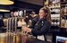 staff member smiling as they pour a drink