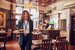 image of wait staff bringing food to table with a smile 