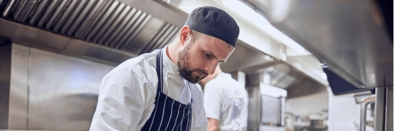 image of kitchen assistants plating up food 
