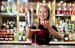 image of pesto bartender pouring a drink with a smile 