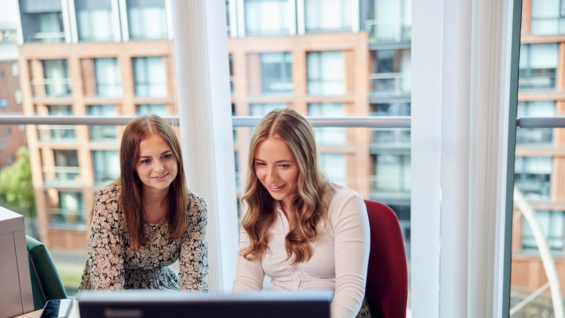 manchester M&B employees sitting at desk looking at laptop