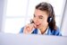 Smiling woman working at call centre in office