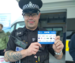 Danny in police uniform holding ESP card
