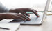 Closeup of afro woman hands typing on laptop keyboard, learning how to write a CV