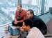 Three professionals around a laptop talking