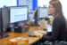 A female at Admiral sat in front of her desk typing on a keyboard and looking at a monitor