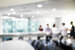 admiral law - blurred image with people sitting on desk in background