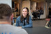 Data apprentice Katie wearing a denim jack sat by a table