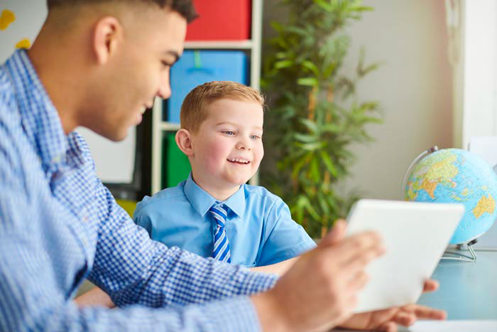 Tutor teaching a smiling student