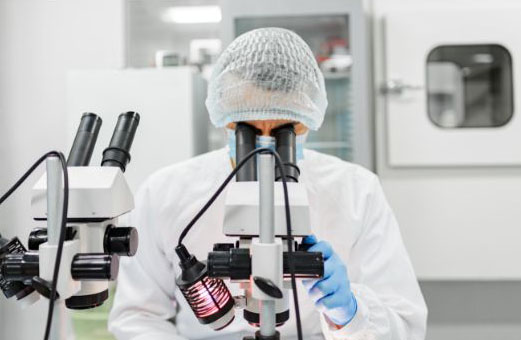 Scientist using a microscope for their labwork