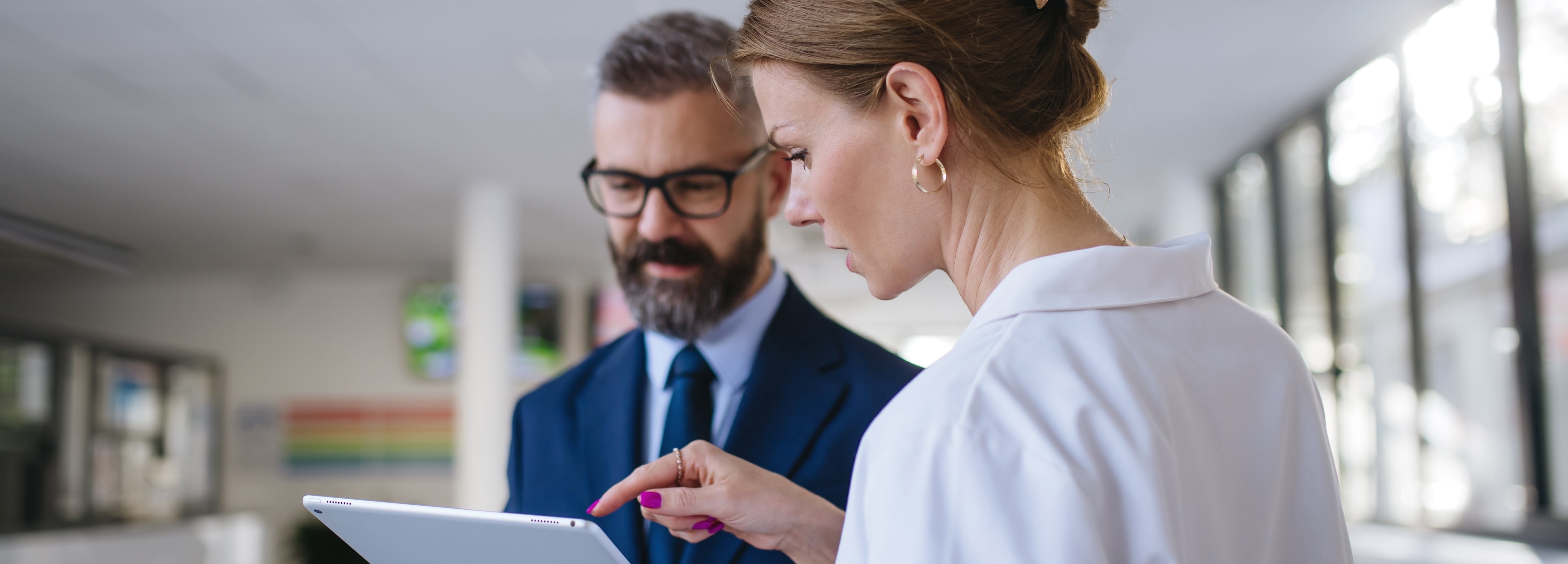 sales representative talking with female doctor in medical building.