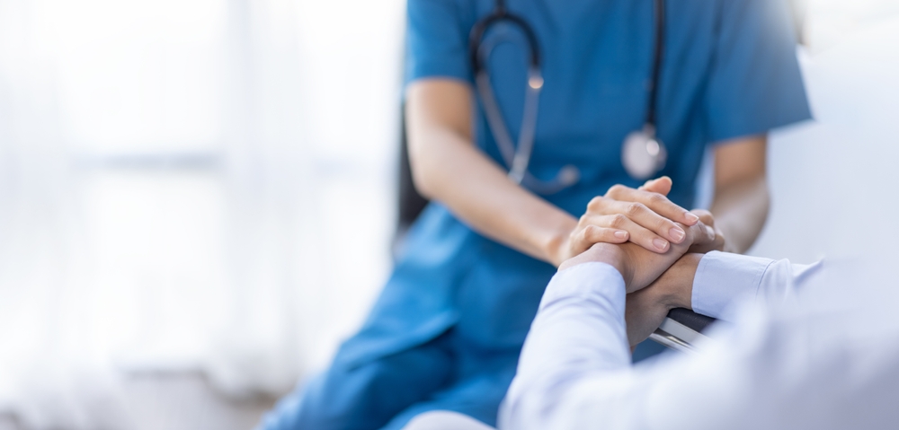 Cropped shot of a female nurse hold her senior patient's hand. Giving Support.