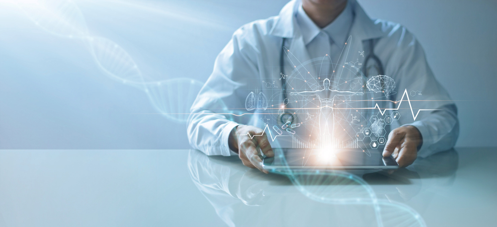 person in a white lab coat and stethoscope holding a tablet with digital images projecting out