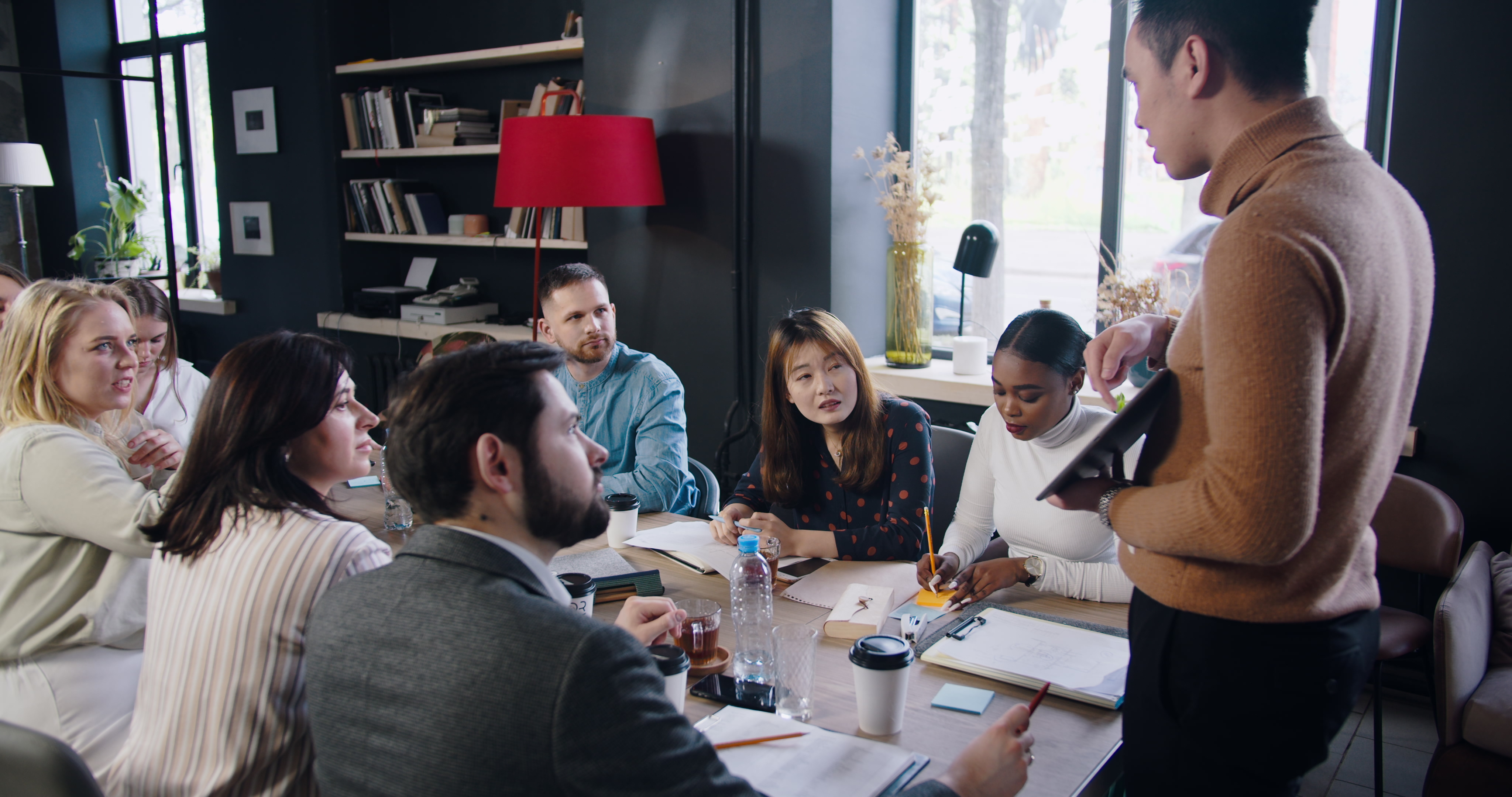 a male medical sales rep standing giving a sales pitch to a seated team