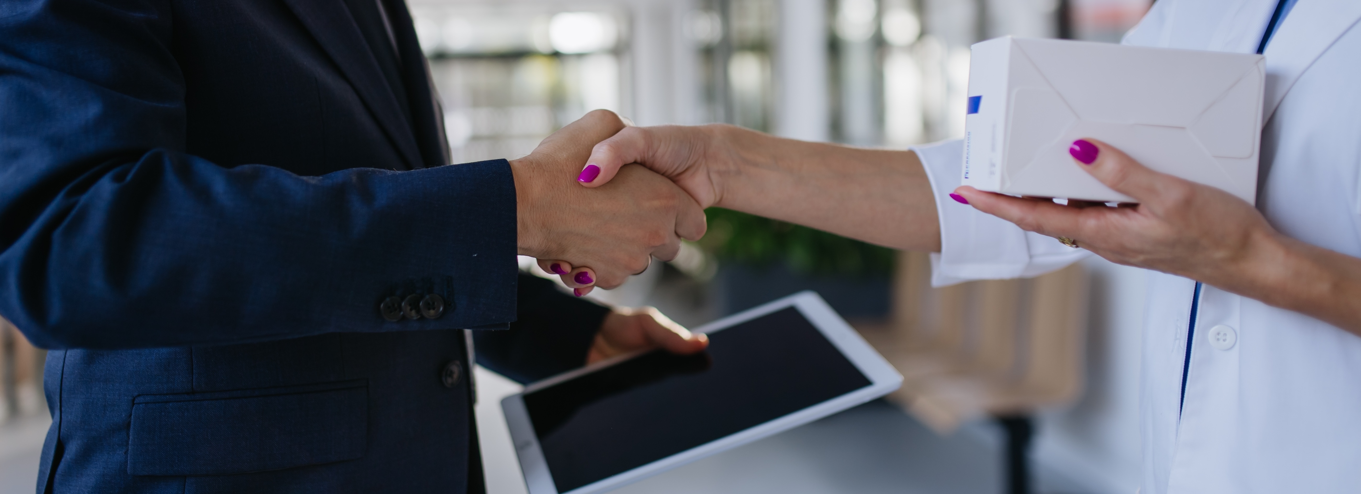 Two sales reps shaking hands.