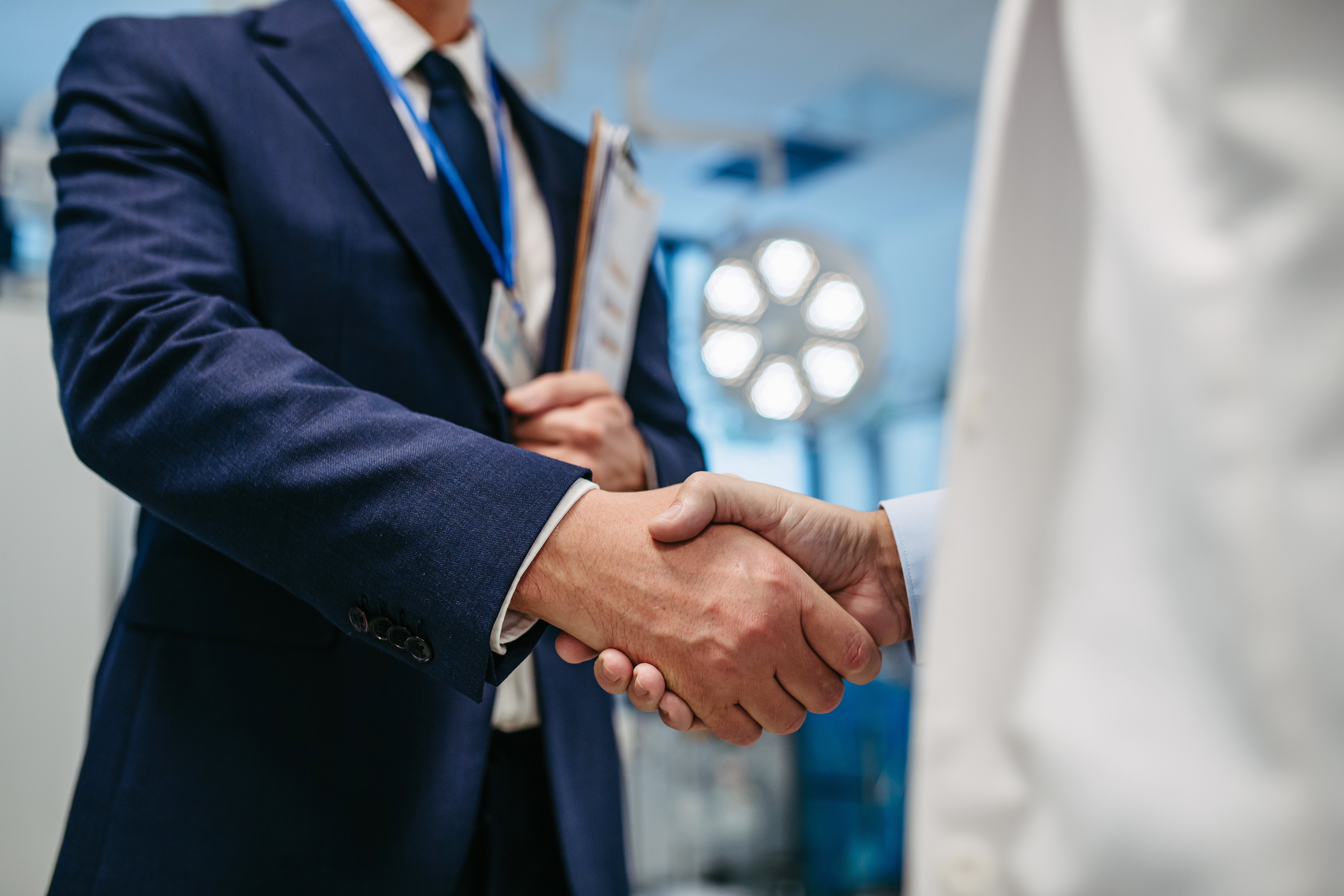 doctor and medical sales representative shake hands