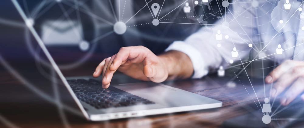 Close-up photo of male hands with laptop. Virtual sales representative working remotely at home. Concept of networking or remote work. Global business network.