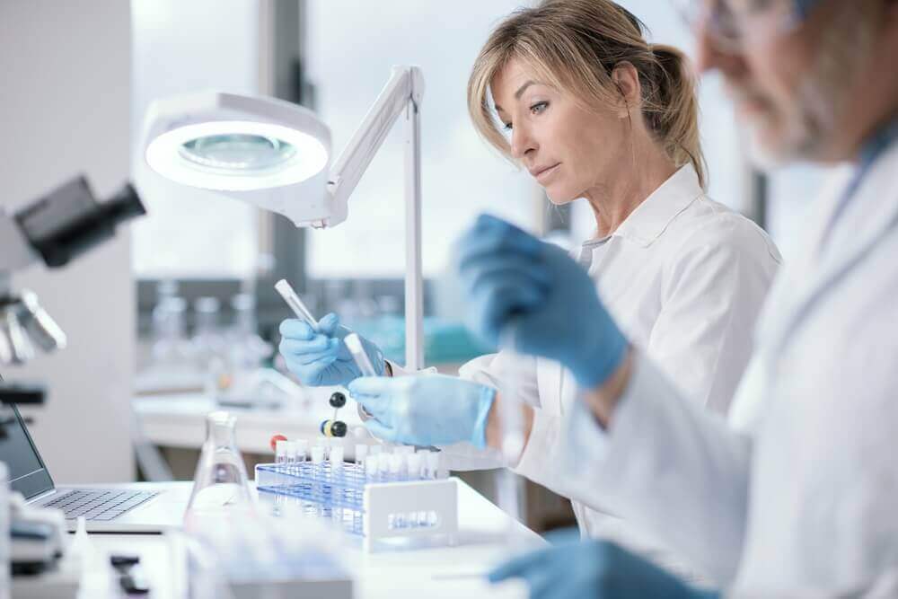 women working in a laboratory looking at test tubes