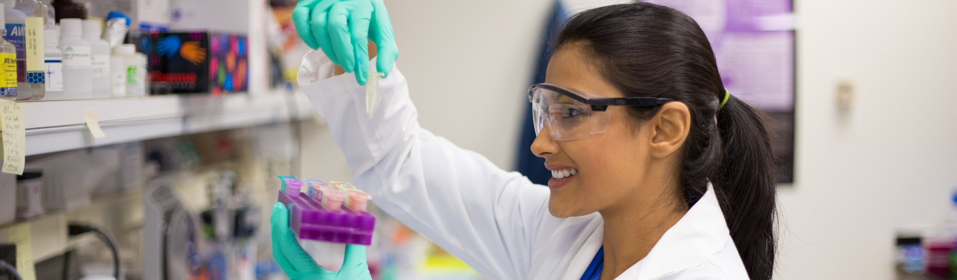 Female in a lab handling test samples