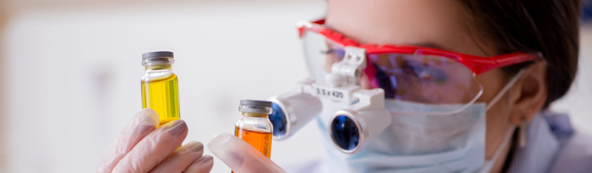 Scientist looking at vials