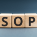 Wooden blocks with the letters SOP