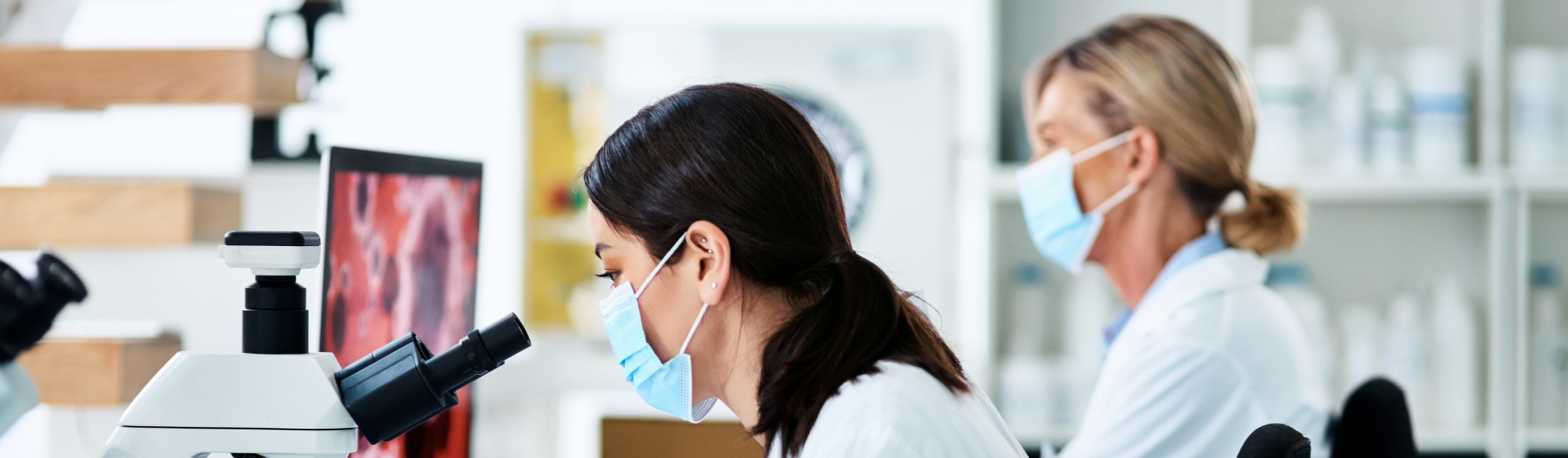 two females in a lab testing samples