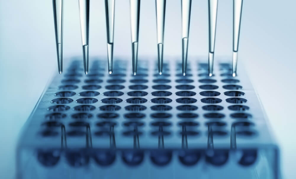 pipette dispensing samples in a deep well plate