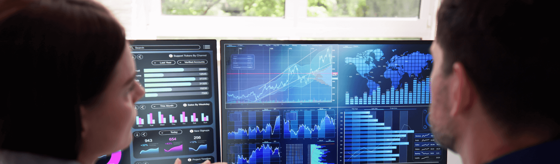 a man and woman looking at a chart on a computer screen