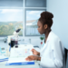 Black female clinician reviewing paperwork