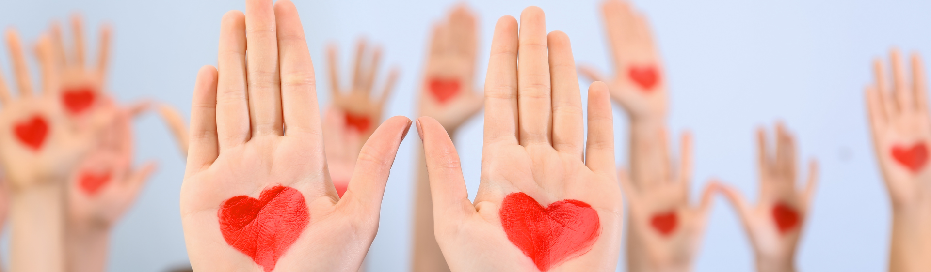 Hands with red hearts drawn in the palm