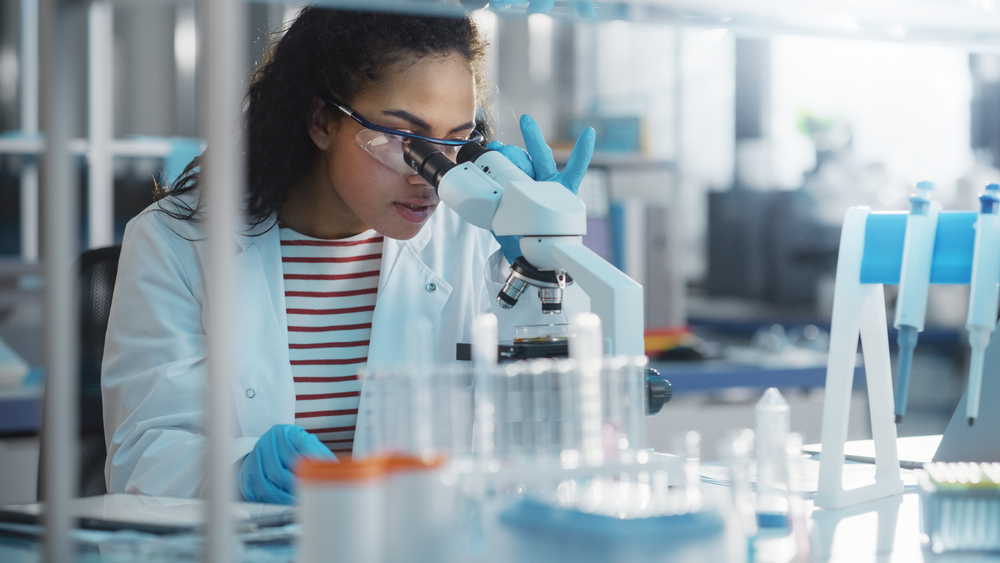 women looking into a laboratory microscope