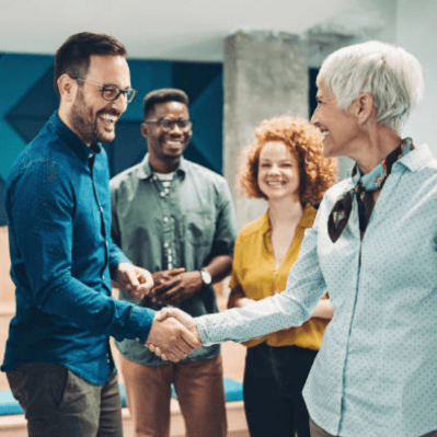 coworkers smiling shaking hands