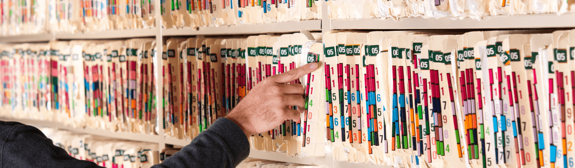 person reviewing documents stored on shelf