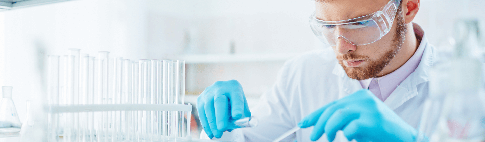 Male in a lab testing samples