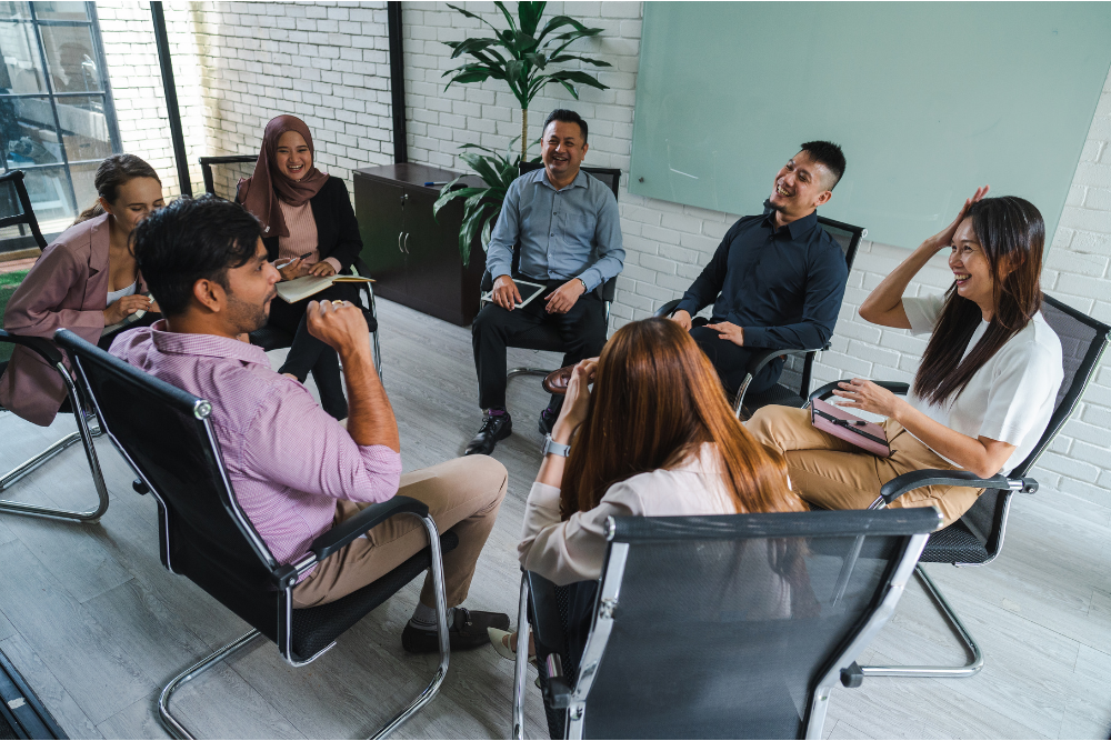 coworkers smiling shaking hands