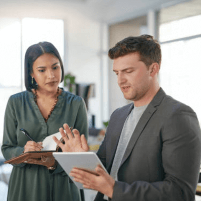 employees looking at a tablet screen