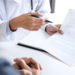 A medic holding a pen and contract