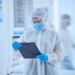 Medic in full gown with a clipboard