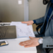 Man at desk with laptop and notes