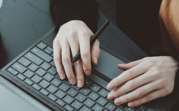 a team member typing on a computer