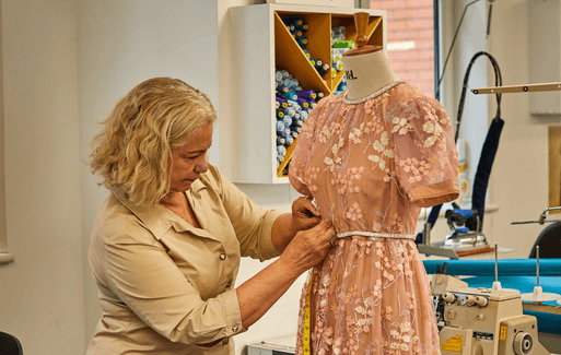 harrods employee measuring a manequin