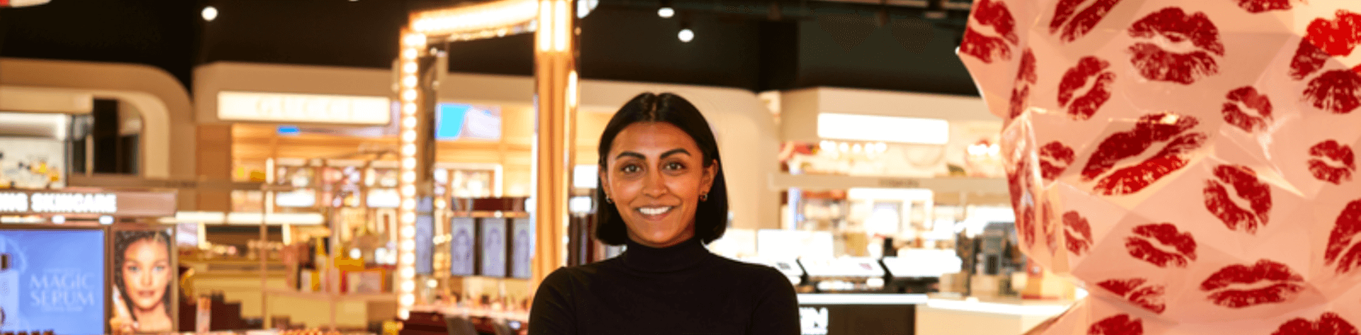 full time retail staff standing with arms crossed smiling