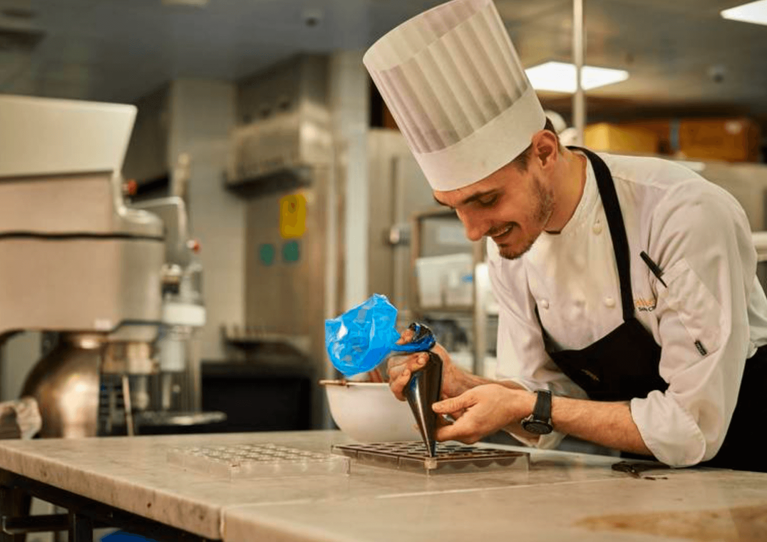 image of pastry chef in london piping some desserts