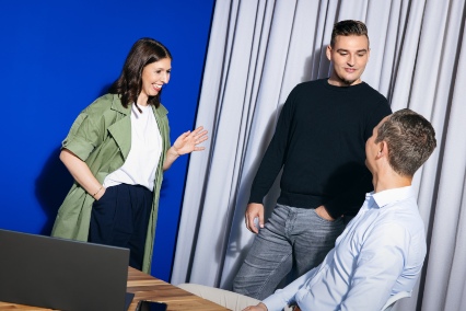 a group of three people engaged in a conversation