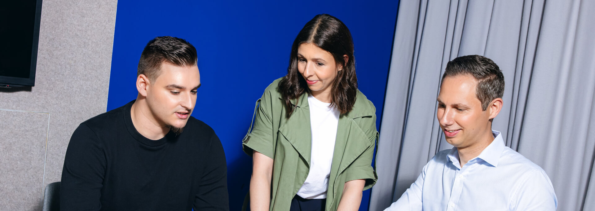 Two men and a woman in a professional discussion