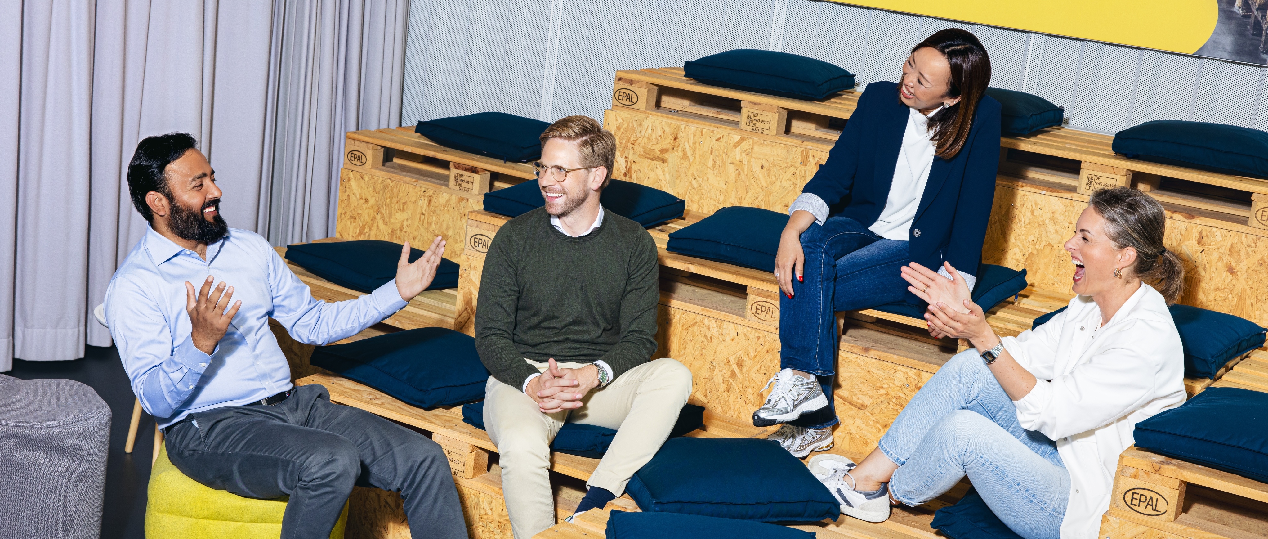 a diverse group of working professionals engaged in a fun conversation