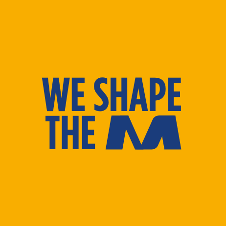 final part of the company manifesto that reads we shape the m written in a bold, blue font across an orange backdrop