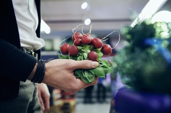 a man holding fresh produce 