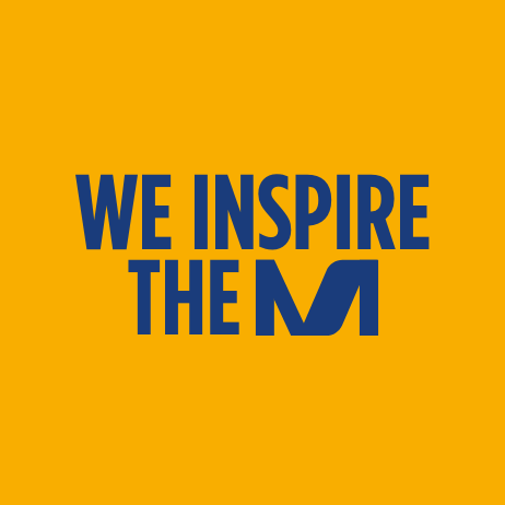 part 3 of the company manifesto that reads we inspire the m written in a bold, blue font across an orange backdrop