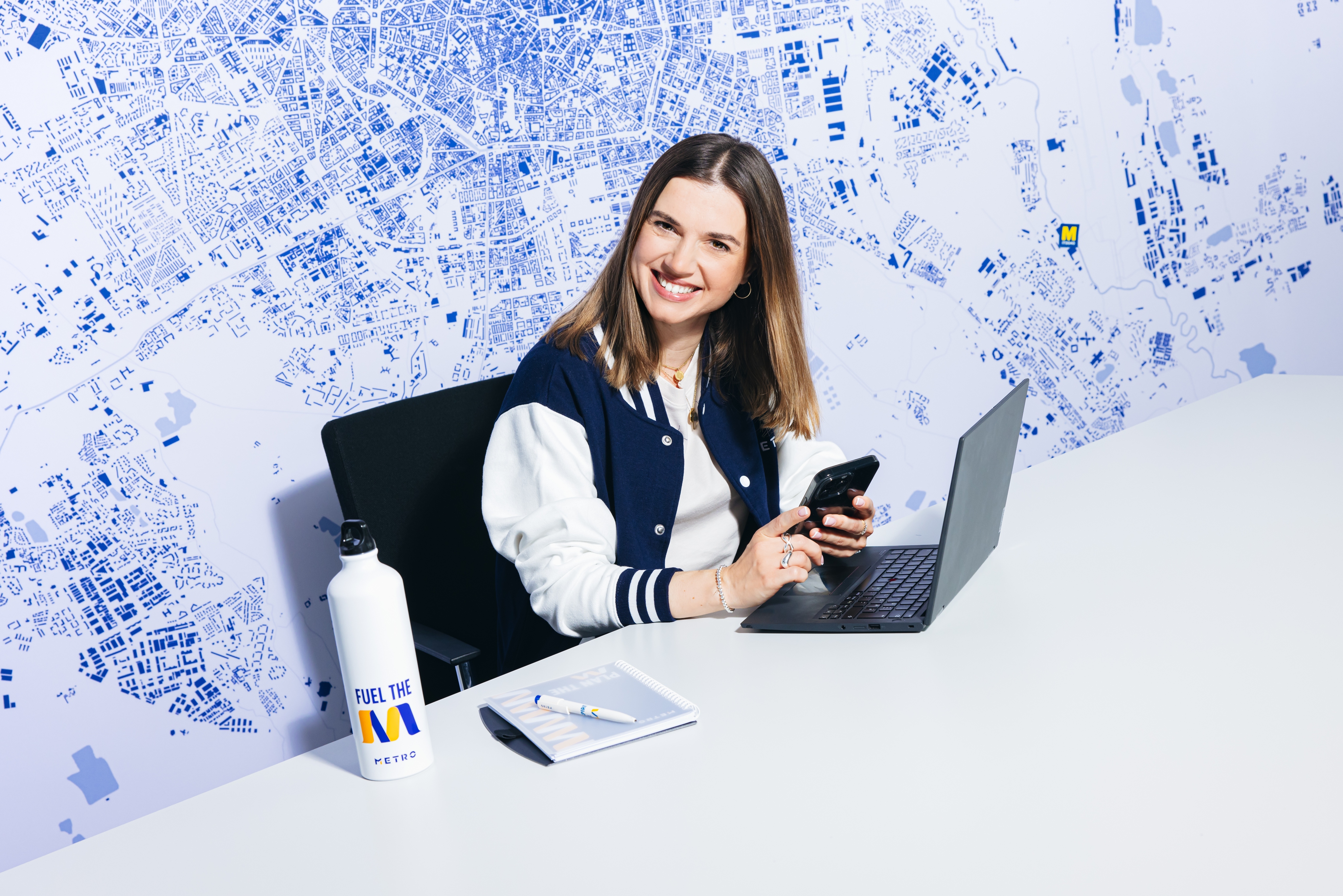 a female professional sitting at her desk with her laptop and work essentials